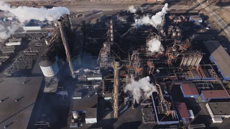 Industrial-complex-with-smoking-chimneys-in-hamilton,-ontario-at-dusk,-aerial-view
