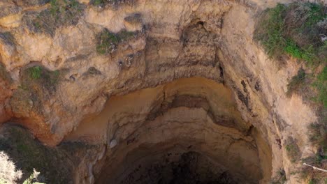 Camera-Tilt-Down-Over-The-Portimao-Sea-Cave-In-Southern-Portugal,-Algarve-Region