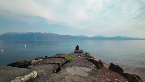 Geneva-River,-with-man-sitting-on-a-wooden-platform