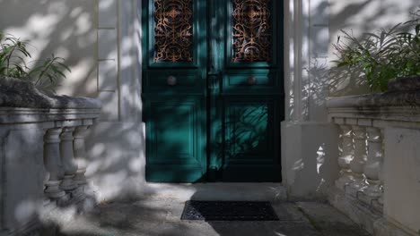 Slow-dolly-shot-revealing-antique-wooden-doors-with-metal-artwork-embedded