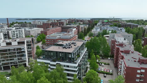 Aerial-view-low-over-modern-condos-on-the-Lauttasaari-island,-spring-in-Helsinki