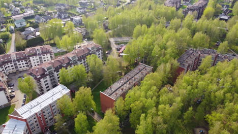 Old-Soviet-era-apartment-buildings-in-small-township-of-Latvia,-aerial-drone-view