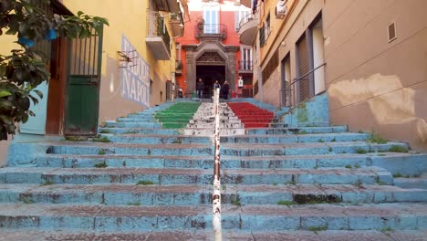 People-Walking-Down-Staircase-With-Colors-Of-Italian-Flag-In-Naples,-Italy