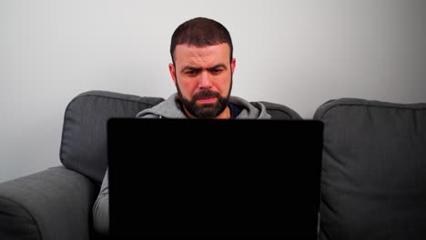 Middle-Eastern-Caucasian-Man-Thinking-Seriously-While-Working-In-Front-Of-Laptop