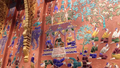 colored-glass-mosaics-of-Wat-Xieng-Thong-buddhist-temple-in-Luang-Prabang,-Laos-traveling-Southeast-Asia