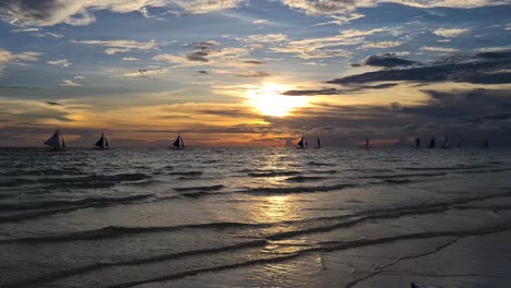 Sunset-on-Boracay-Island,-Philippines,-Silhouettes-of-Sailboats-and-Beautiful-Sky