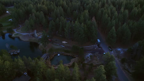 Aerial-View-of-Small-Isolated-American-Community,-Homes-and-Lake-Deep-in-Forest-at-Daybreak