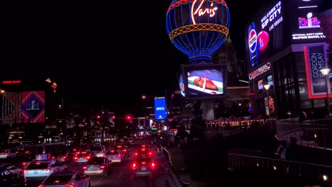 Las-Vegas-Nevada-USA,-Traffic-Jam-on-Strip-at-Night,-Shiny-Billboards-and-Lights-on-Paris-Hotel-Casino