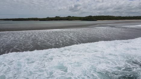 Drone-approximation-from-the-pacific-ocean-towards-Natadola-beach,-Fiji