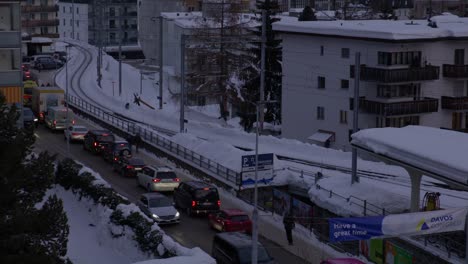 Right-to-left-panning-shot-showing-the-main-road-outside-of-the-train-station-of-Davos-at-dusk-during-the-World-Economic-Forum