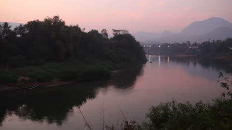 pink-dusk-after-sunset-over-river-in-Luang-Prabang,-Laos-traveling-Southeast-Asia