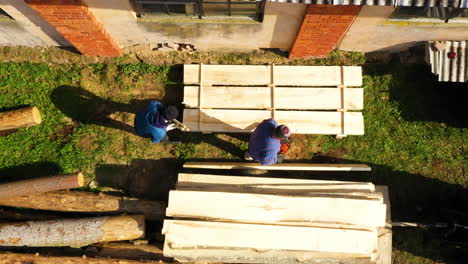 Aerial-top-down-of-male-worker-on-sawmill-industry-during-sunny-day-in-Lativa