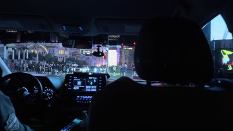 Inside-view-from-a-car-on-the-Las-Vegas-Strip-at-night,-showcasing-vibrant-street-scenes-and-the-illuminated-Mirage-Hotel