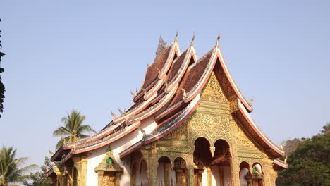 golden-facade-of-buddhist-temple-in-Luang-Prabang,-Laos-traveling-Southeast-Asia