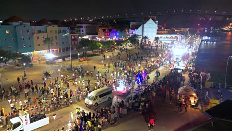 Aerial-orbit-above-people-watching-Carnaval-parade-at-night-with-joy