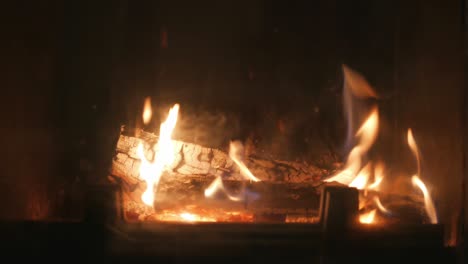 Fire-burns-logs-in-fireplace,-beautiful-flames