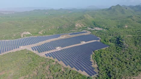 Aerial-orbit-large-solar-panel-park-admits-rural-mountainous-Caribbean-landscape