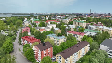 AERIAL-Colorful-apartment-buildings-on-the-Lauttasaari-island,-spring-in-Helsinki