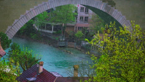 Aare-river,-slow-motion-heavy-rain-under-Nydegg-bridge,-Bern,-Switzerland