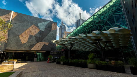Timelapse,-Melbourne-Australia-Federation-Square,-Modern-Buildings-and-People-Under-Light-Clouds