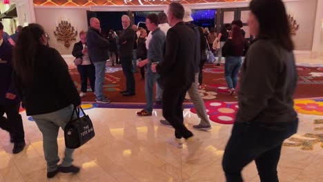 Lively-crowd-inside-a-Las-Vegas-venue-before-the-'Awakening'-show,-with-colorful,-ornate-decor,-capturing-the-essence-of-vibrant-nightlife