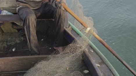 Skilfull-fishermen-from-Muncar,-The-time-honored-technique-passed-down-through-generations-involves-pouring-the-nets-into-the-sea-using-a-bombe,-ensuring-that-all-the-nets-are-cast-effectively