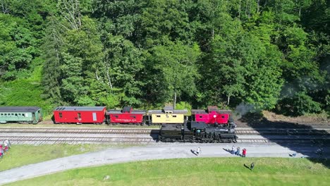 An-Aerial-View-of-an-Antique-Steam-Locomotive-Backing-Up-Slowly-to-Approach-a-Station-on-a-Sunny-Summer-Morning