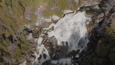 Aerial-shot-of-Owen-Sound-waterfall-in-Ontario,-lush-forest-surroundings-in-daylight