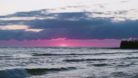 Vibrant-sunset-over-Owen-Sound-with-waves,-Ontario,-Canada,-serene-mood,-dusk-sky