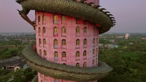 Wat-Sam-Phran-Dragon-Temple,-Rotating-Drone-View-Up-close-at-sunset