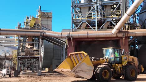 Heavy-Duty-Front-Loader-Scooping-Wood-Chips-at-Pellet-Processing-Plant