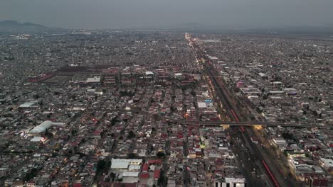 Panoramic-aerial-view-of-Ecatepec-neighborhood,-CDMX-Suburbs,-Sunset-Illuminates-City