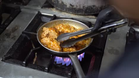 Cooking-fried-chicken-pieces-in-a-frying-pan