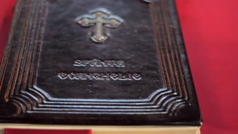 Handheld-shot-of-the-holy-book-on-a-table