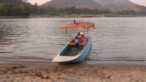 boat-dock-on-the-sand-on-the-mekong-river-in-Luang-Prabang,-Laos-traveling-Southeast-Asia
