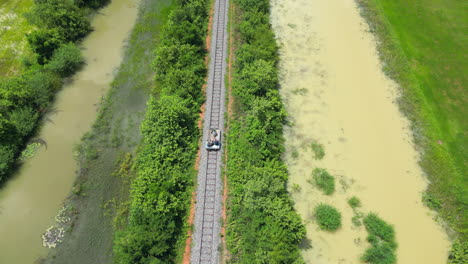 Riding-The-Bamboo-Railway-Through-Green-Cambodian-Fields-Near-Battambang-Pan-Up