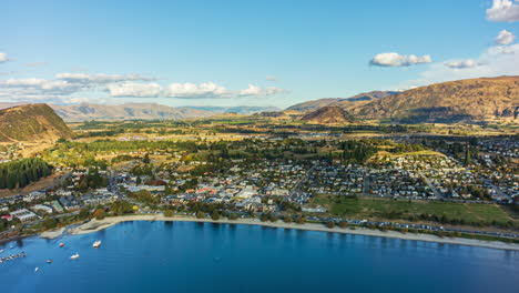 Aerial-timelapse-over-city-of-Wanaka,-New-Zealand,-on-shore-of-Lake-Wanaka