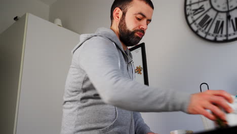 Portrait-Of-Middle-Eastern-Man-Cleaning-Up-Table-After-Breakfast