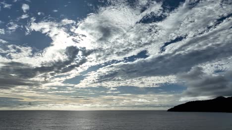 Moody-sunset-skies-over-Ocean-waters,-West-Coast,-Weh-Island,-aerial