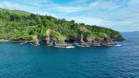 Deep-blue-ocean-water,-blue-sky,-picturesque-coastal-scenery,-aerial