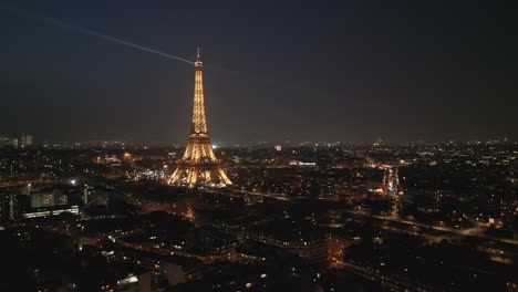 Tour-Eiffel-Tower-illuminated-at-night-with-light-show-from-top,-Paris,-France