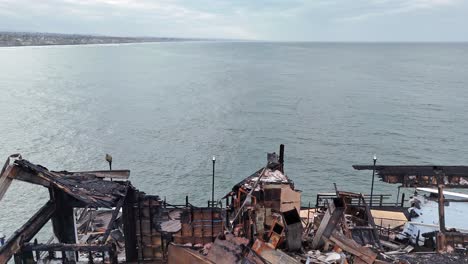 Oceanside-California-Pier-Fire-Damaged-Former-Rubys-Diner-Restaurant-Drone-Backwards-Reveal-South-To-North