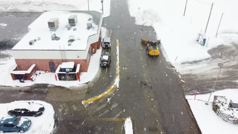 Bulldozer-Removes-Record-Snowfall-from-Parking-Lot-Amidst-the-Storm