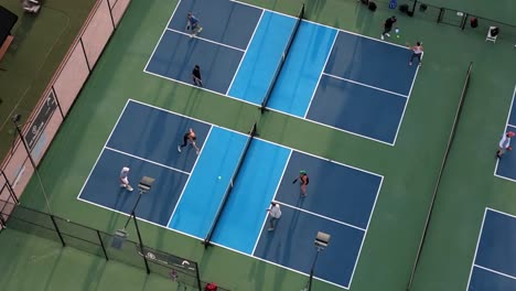 Aerial-view-of-pickleball-court-as-two-games-of-mixed-doubles-play-out