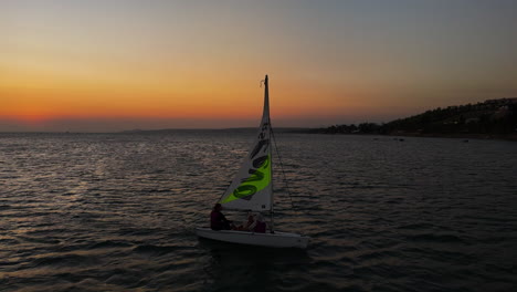 RS-Feva-Dinghy-Sailboat-Returning-To-Shore-In-Mui-Ne-Bay,-Vietnam