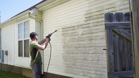 Pressure-washing-the-side-of-a-house
