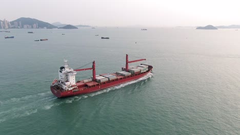 Mega-Container-Ship-leaving-Hong-Kong-port,-Aerial-view