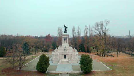 Budapest,-Hungary,-Flying-over-Kerepesi-Cemetery-by-Drone-in-autumn,-golden-and-brown-leaves,-hazy,-foggy-weather