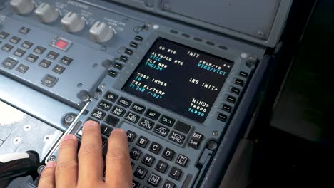 Pilot-checking-parameters-on-MCDU-multipurpose-control-display-unit