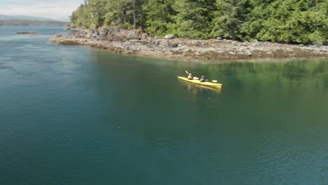 Aerial-footage-of-two-people-in-yellow-ocean-kayak-on-the-ocean